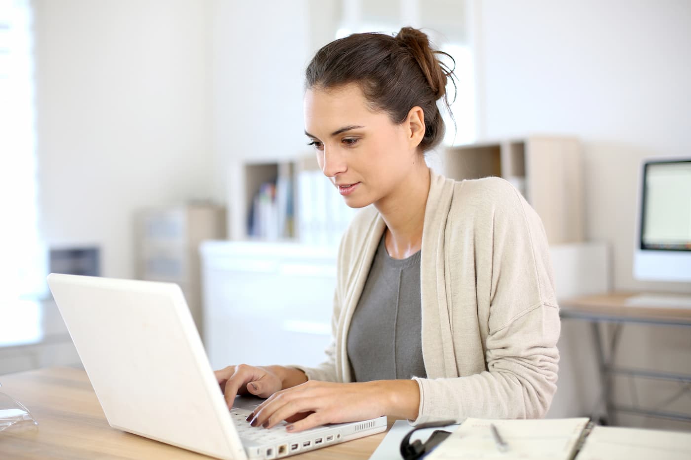 Small business owner making confident website investment decision at modern office desk